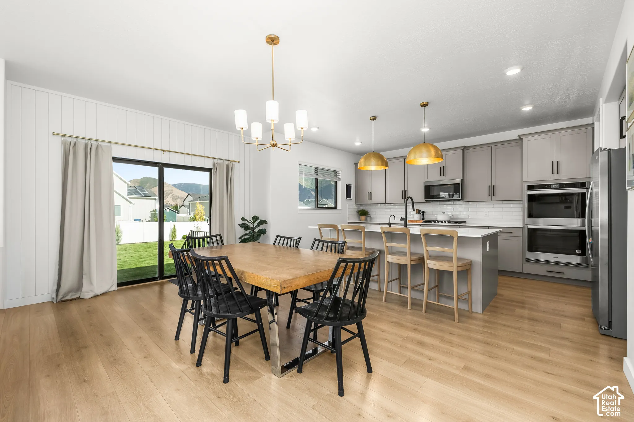 Open-concept kitchen and dining area featuring wood-finish flooring