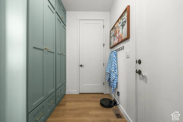Built-in cabinetry with paneled doors, brass hardware, and integrated drawer storage