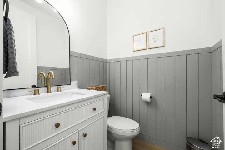 Vanity with integrated sink, gold-finish faucet, and arched mirror
