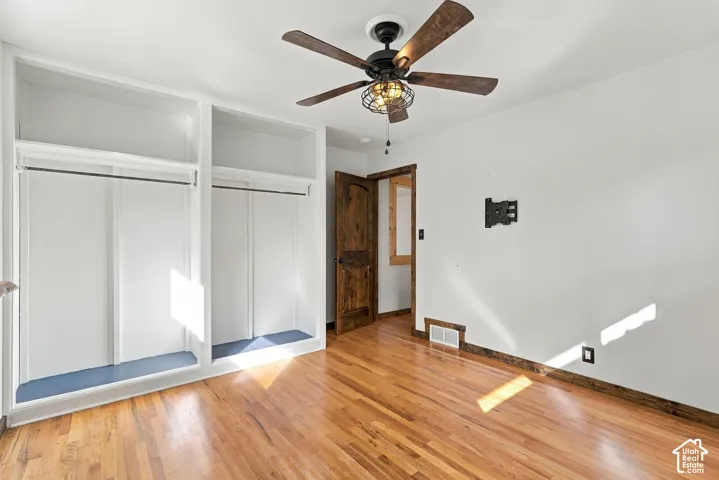 Wood-finish flooring with white walls and dark wood-finish trim