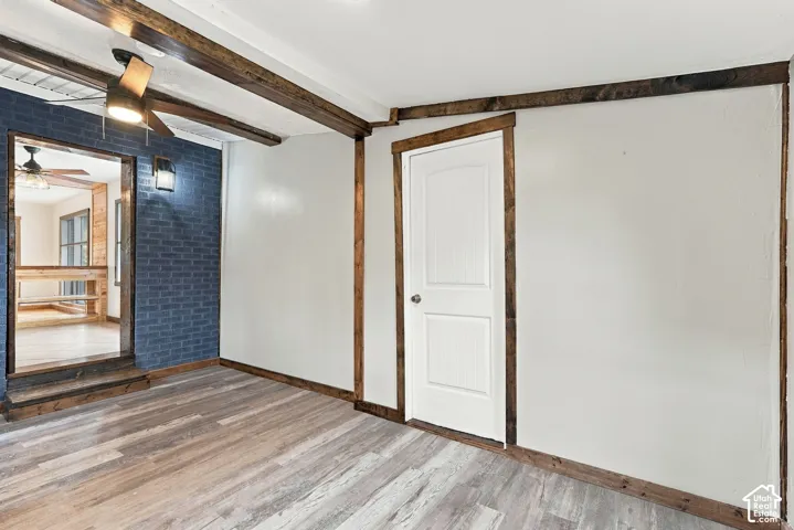 Wood-finish flooring with exposed wood beams and trim