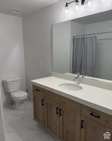 Floating wood-finish vanity with ample storage, integrated white countertop with undermount sink, and a large mirror