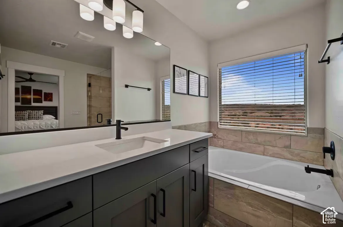 Modern vanity with an integrated sink, black hardware, and a stone-finish countertop