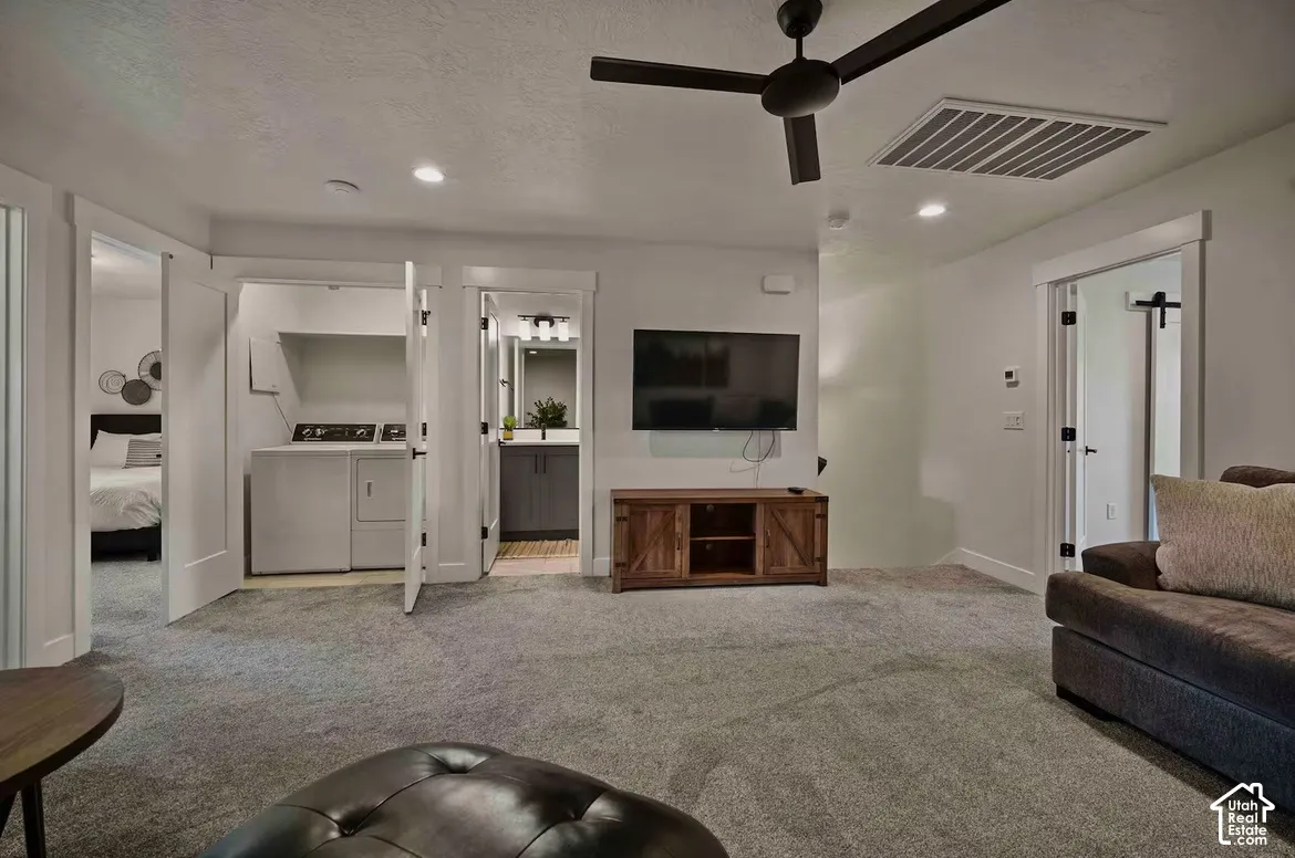 Recessed lighting, ceiling fan, built-in media console, laundry closet, and a vanity with an undermount sink