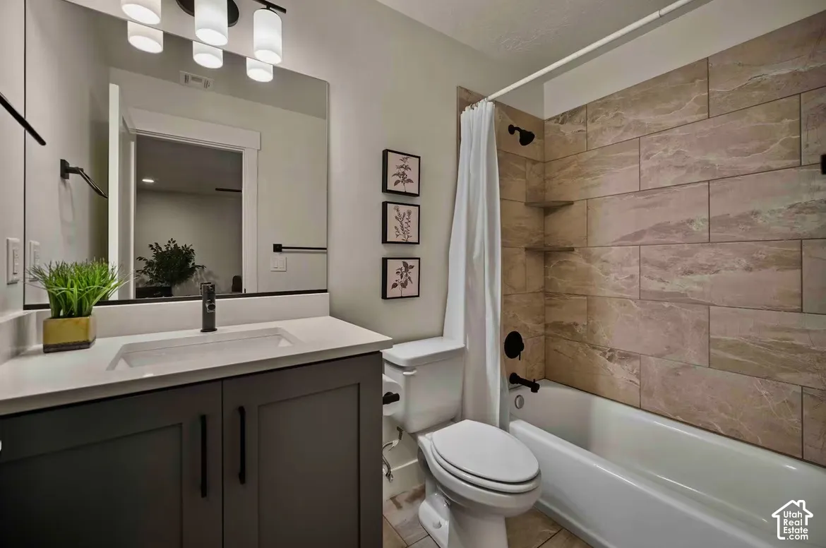 White vanity with dark cabinetry and black hardware