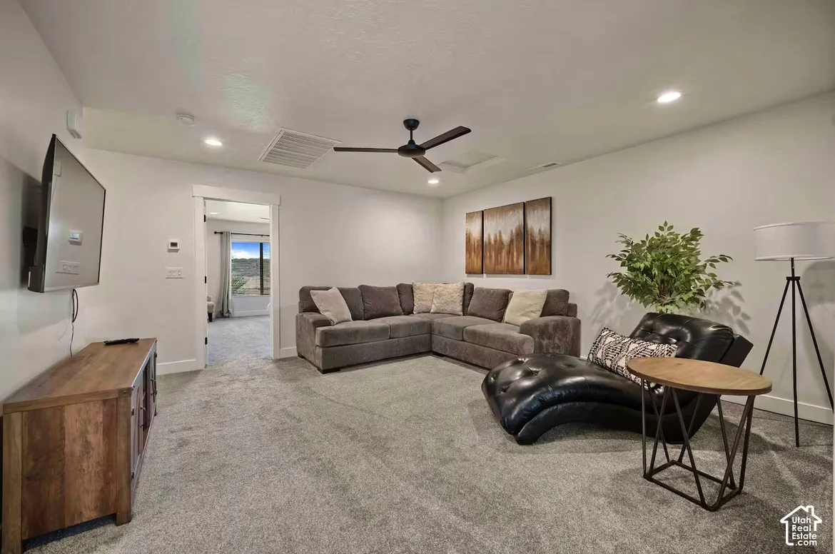 Recessed lighting, ceiling fan, and carpeted flooring