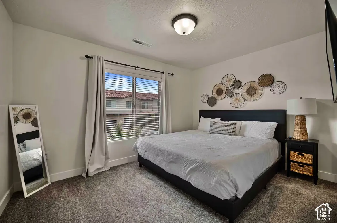 Carpeted flooring, recessed window, ceiling-mounted light fixture, and white wall finishes