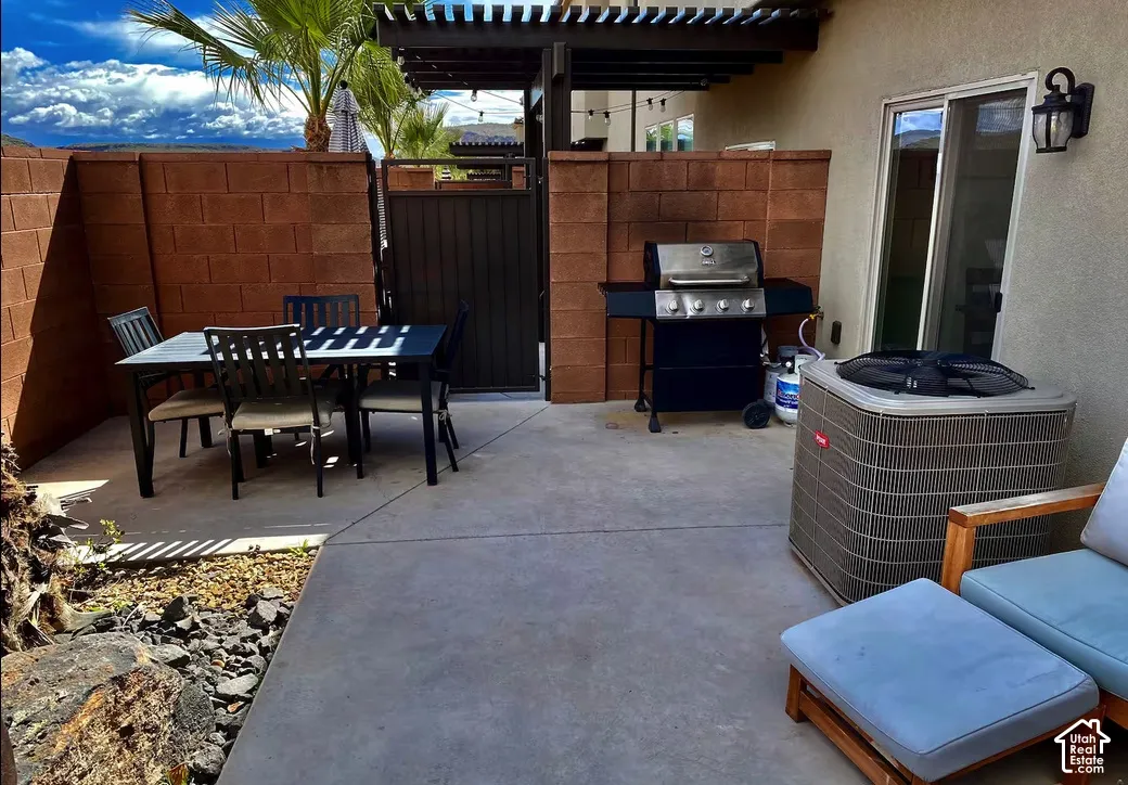 Private patio space featuring a concrete slab, block wall, and sliding glass door access