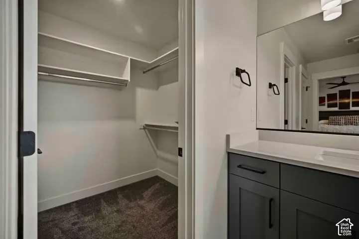 Walk-in closet with built-in shelving and hanging rods