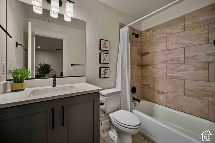 White vanity with dark cabinetry and black hardware