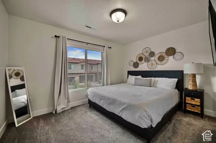 Carpeted flooring, recessed window, ceiling-mounted light fixture, and white wall finishes