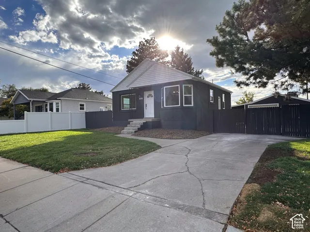 Exterior featuring a gabled roof, dark siding, and white trim
