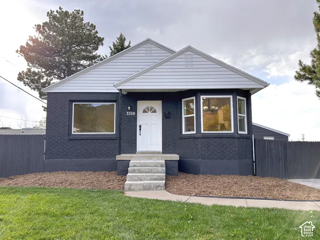 Black brick exterior with gray siding and white trim