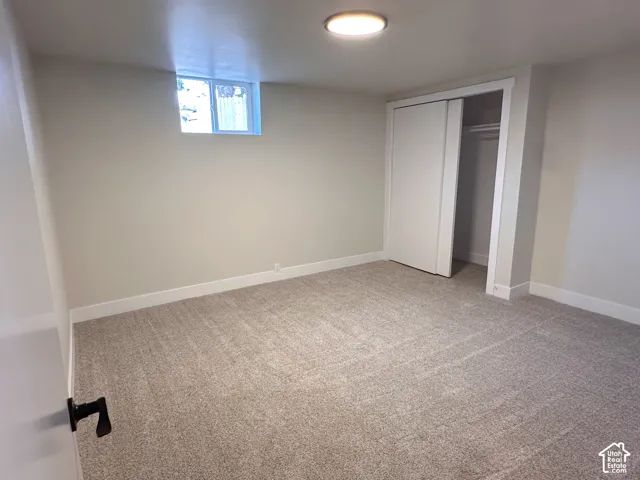 Wall-to-wall carpeting, window, and sliding closet doors