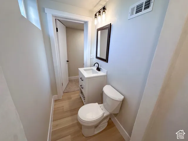 White vanity with an integrated sink, matte black faucet, and rectangular framed mirror