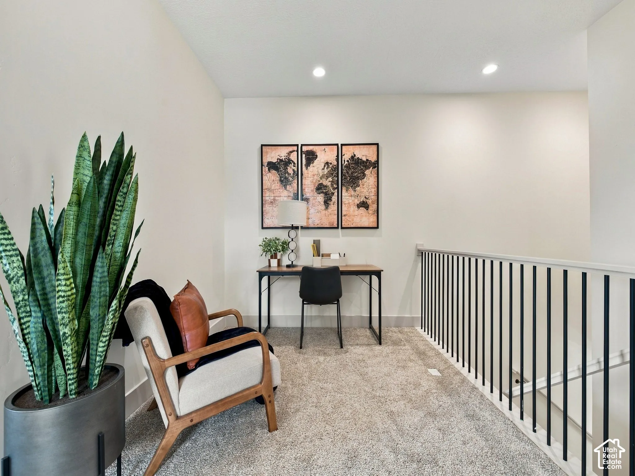 Carpeted loft area featuring recessed lighting, a desk, and a modern black spindle railing