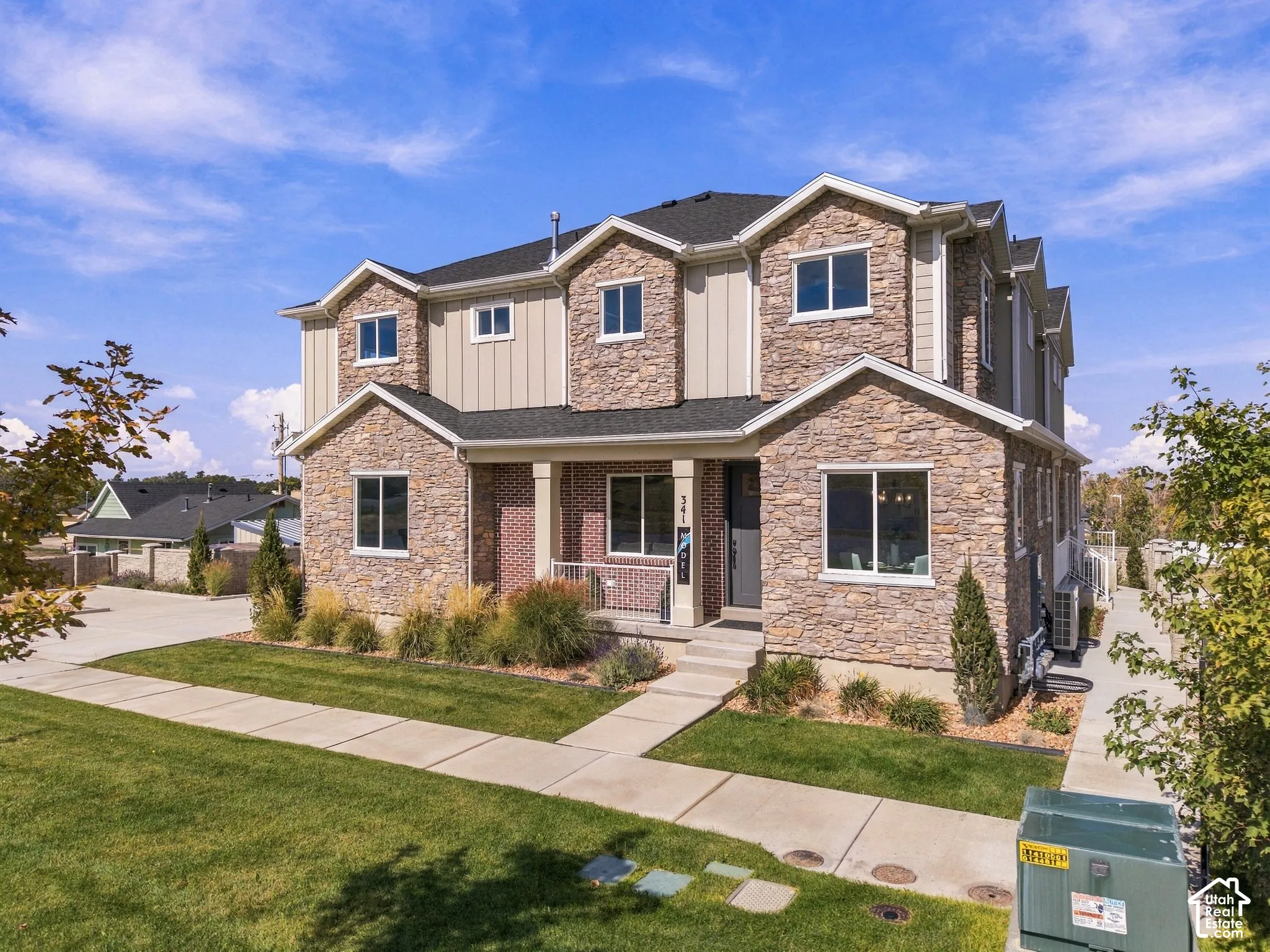 Contemporary stone and siding exterior with multiple gables