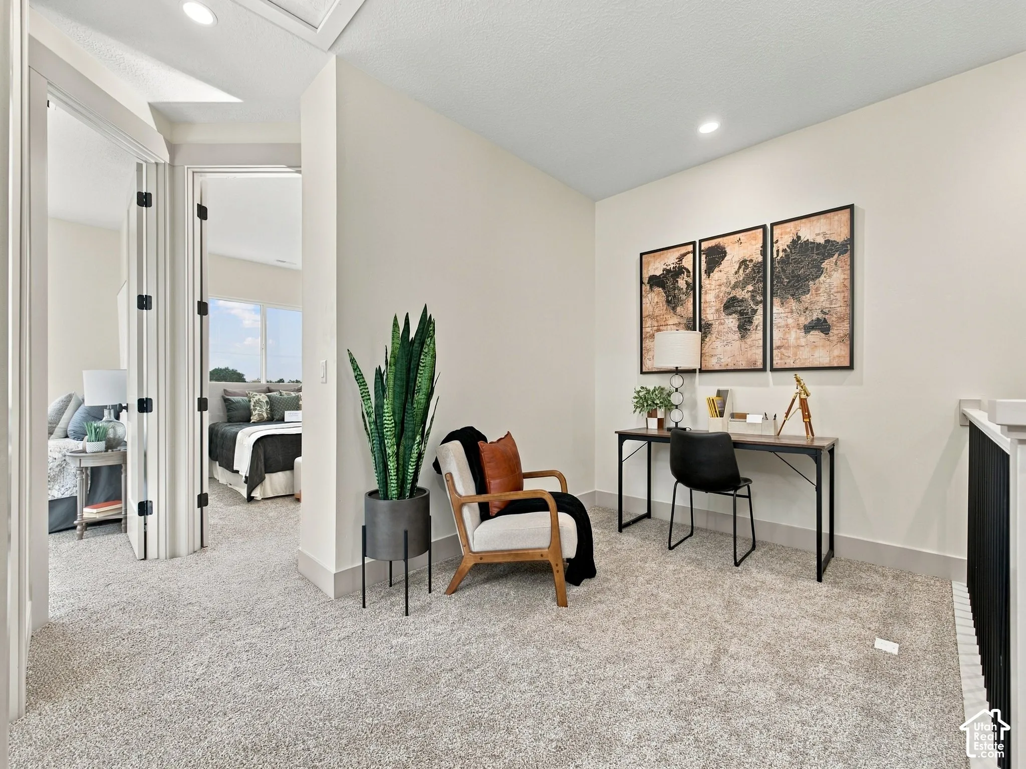 Carpeted hallway with painted walls, recessed lighting, and white trim