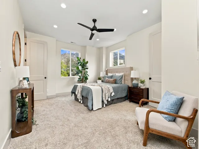 Plush carpet flooring, recessed lighting, and a ceiling fan create a comfortable atmosphere