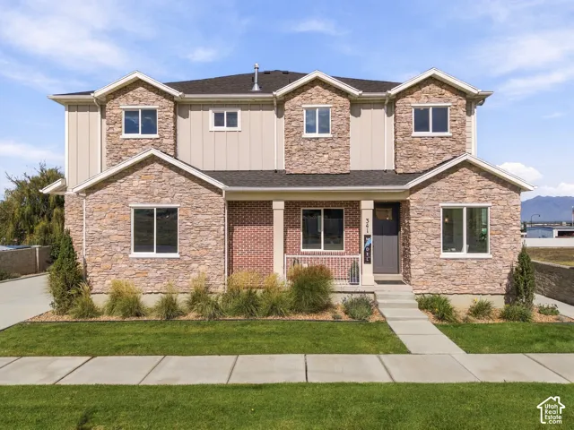 Stone and siding exterior with a covered entry