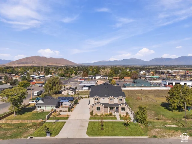 Two-story property with a multi-gabled roof, stone and siding exterior, and a paved driveway