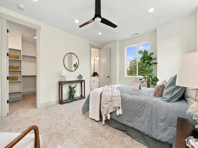 Recessed lighting, ceiling fan, soft neutral wall color, built-in closet shelving, and carpeted flooring