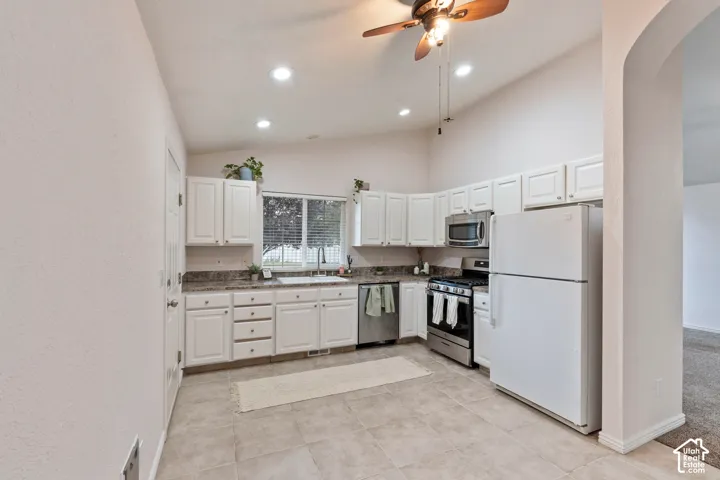 Kitchen featuring white cabinetry, stainless steel appliances, a ceiling fan, recessed lighting, and tile flooring