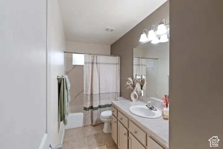 Vanity with integrated sink, overhead vanity lighting, and wall-mounted mirror