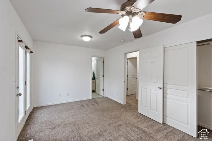 Master Bedroom featuring a ceiling fan with integrated lighting, a flush-mount ceiling light, a sliding closet door, and a glass-paneled exterior door