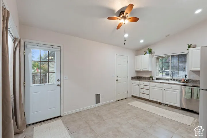 Kitchen featuring white cabinetry, stone-finish countertops, stainless steel appliances, and tile flooring