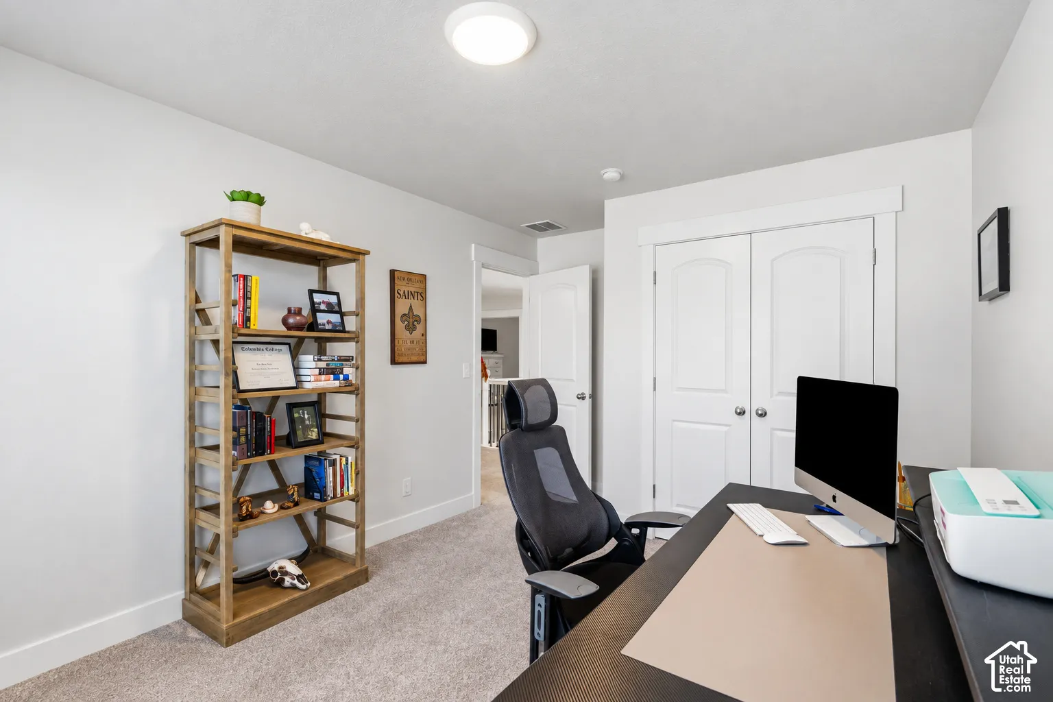 Plush carpet flooring, white painted walls, recessed ceiling lighting, and white bi-fold closet doors.