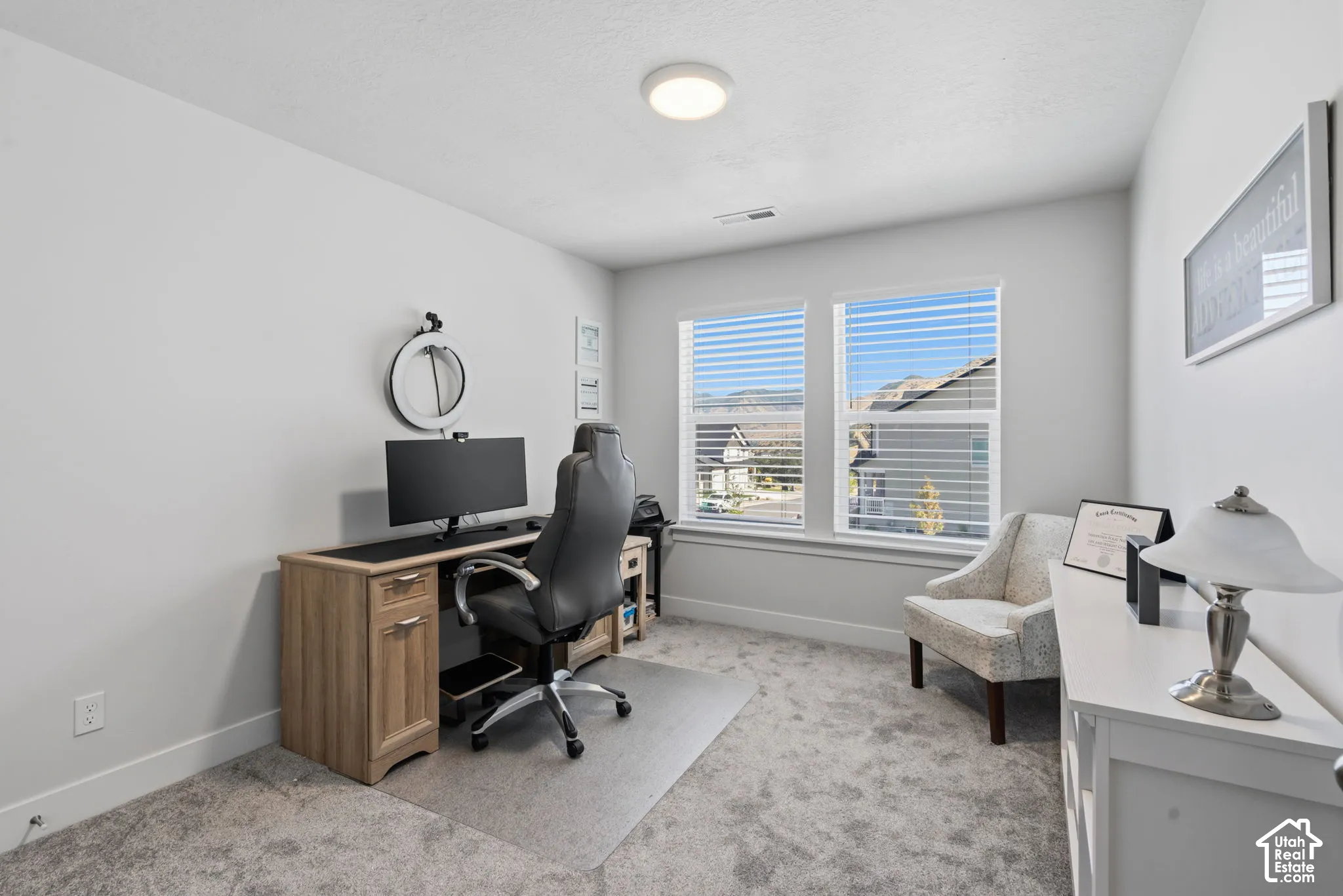 Dual windows with horizontal blinds, providing ample natural light.