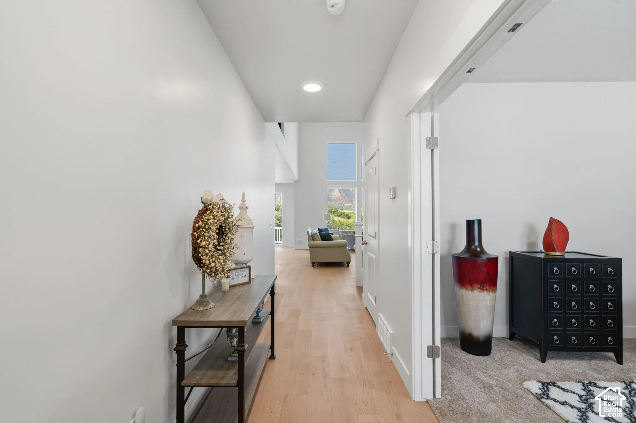 Expansive hallway featuring LPV flooring, recessed lighting, and a prominent window.