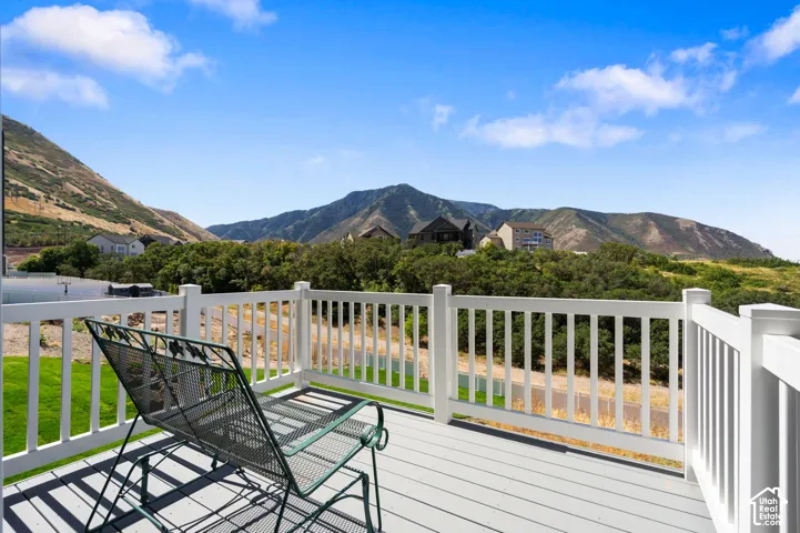 Exterior deck featuring composite decking, white railing, and a scenic mountain backdrop.