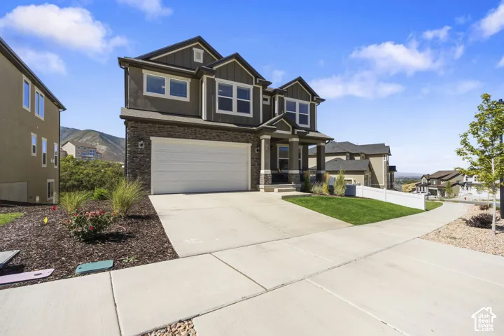 Contemporary two-story residence with a gray exterior and dark roof.
