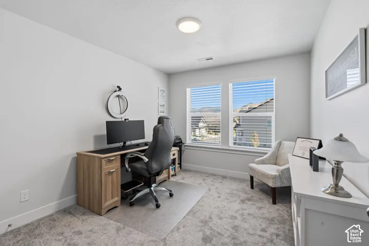Dual windows with horizontal blinds, providing ample natural light.