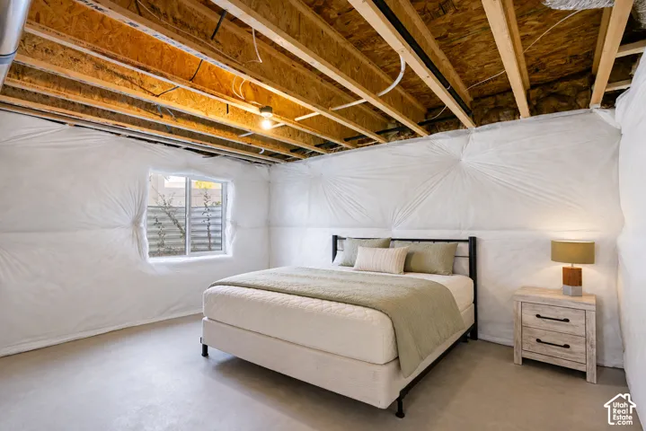 FUTURE BEDROOM...Daylight window, exposed ceiling joists, overhead lighting fixture, insulated walls, concrete flooring.