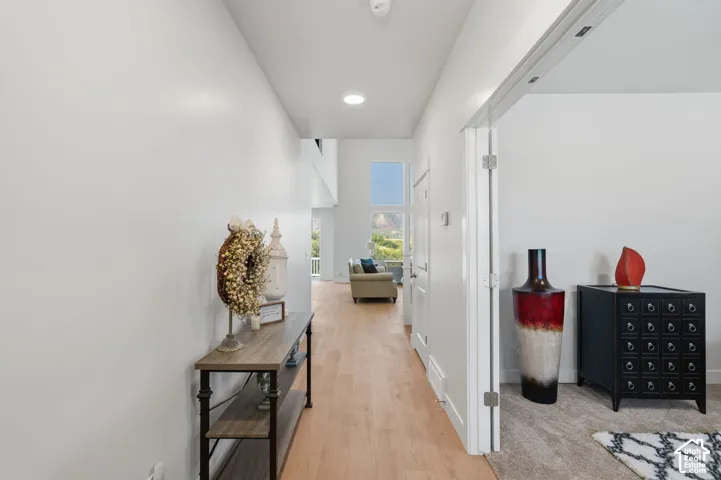 Expansive hallway featuring LPV flooring, recessed lighting, and a prominent window.