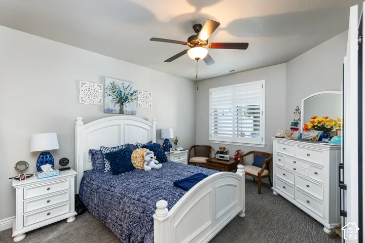 Recessed lighting, ceiling fan with integrated light fixture, window with plantation shutters, and textured carpet flooring