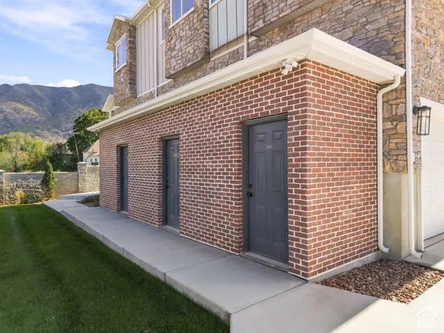 Red brick exterior with stone accents and vertical siding details