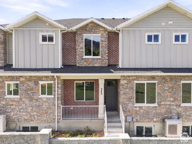 Stone and brick facade with board and batten accents