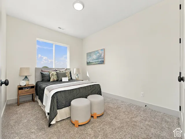 Recessed ceiling lighting, large window with natural light, neutral wall colors, textured carpeting, and white trim