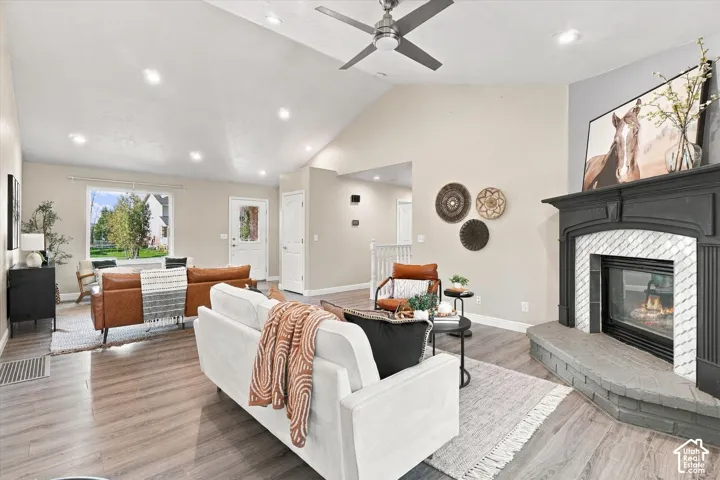 Bright, open living area featuring hardwood flooring, recessed ceiling lighting, and a ceiling fan