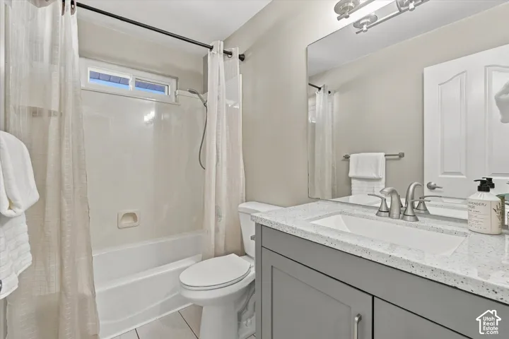 Vanity with a light-toned countertop, under-mount sink, and dual-handle faucet