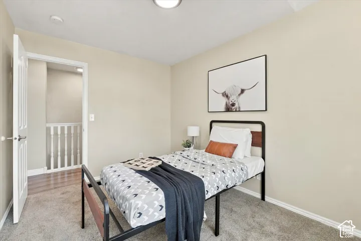 Recessed ceiling lighting, neutral wall finishes, and textured carpeting