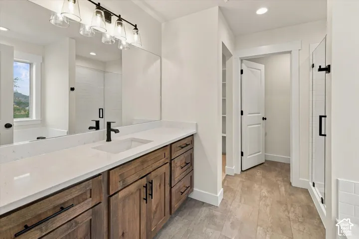 Dual-sink vanity with wood-finish cabinetry and light-toned countertop