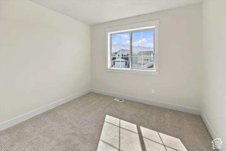 Bright interior with neutral carpet flooring and white trim