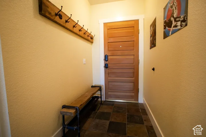 Warm-toned walls complement the paneled wood entry door
