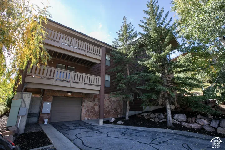 Multi-level exterior featuring wood siding and stone accents