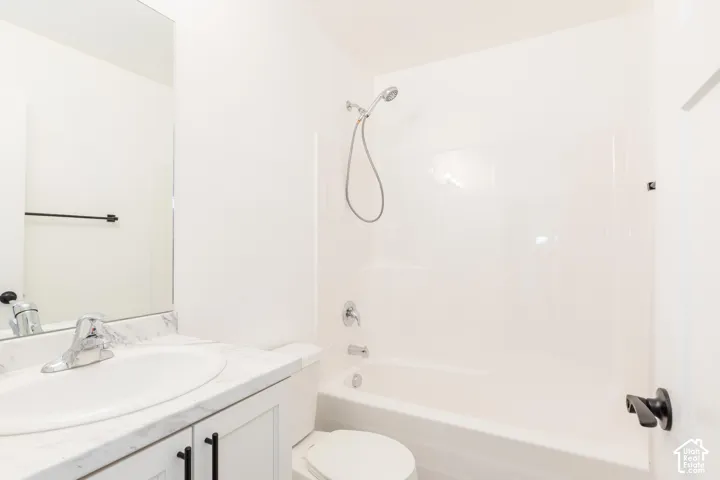 White vanity with an integrated sink and white countertop